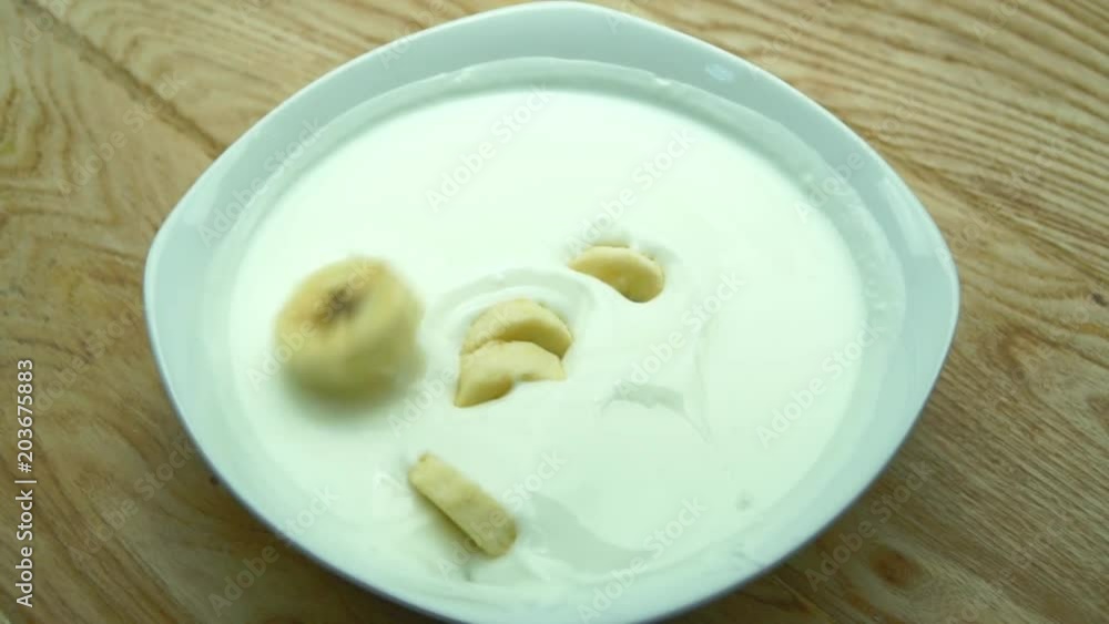 High quality video of slices of banana falling into yogurt. Slow motion. High quality video of slices of banana falling into yogurt. Slow motion.