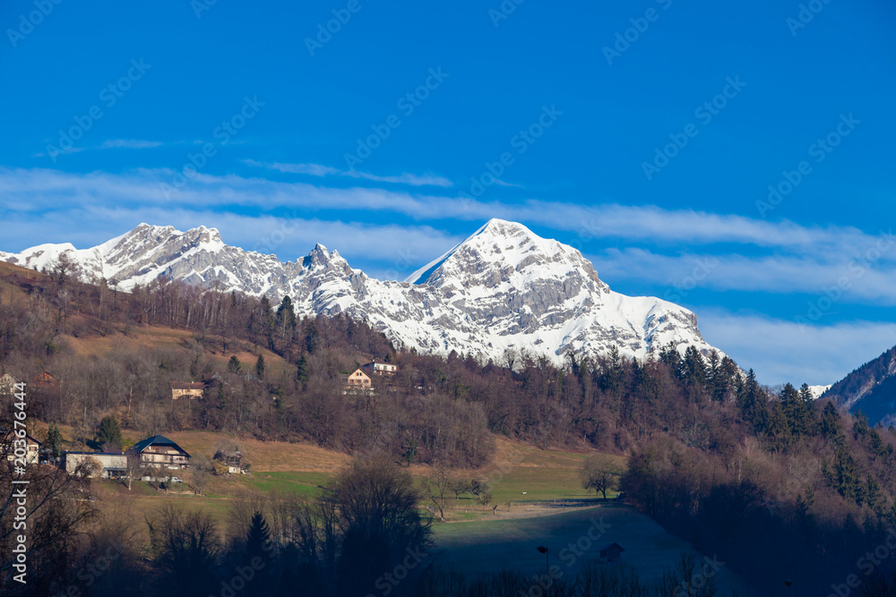 Beautiful view to snow mountain in french alps with village on hill . Winter 2018, France