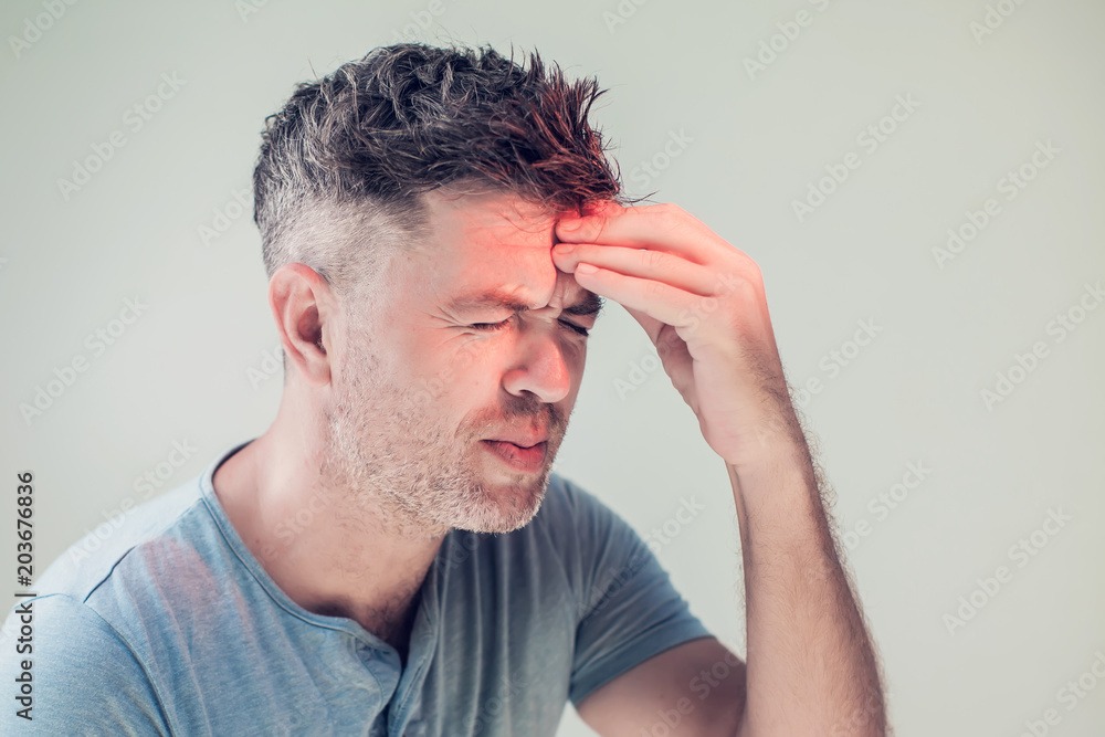 Obraz premium Handsome young man suffering from headache