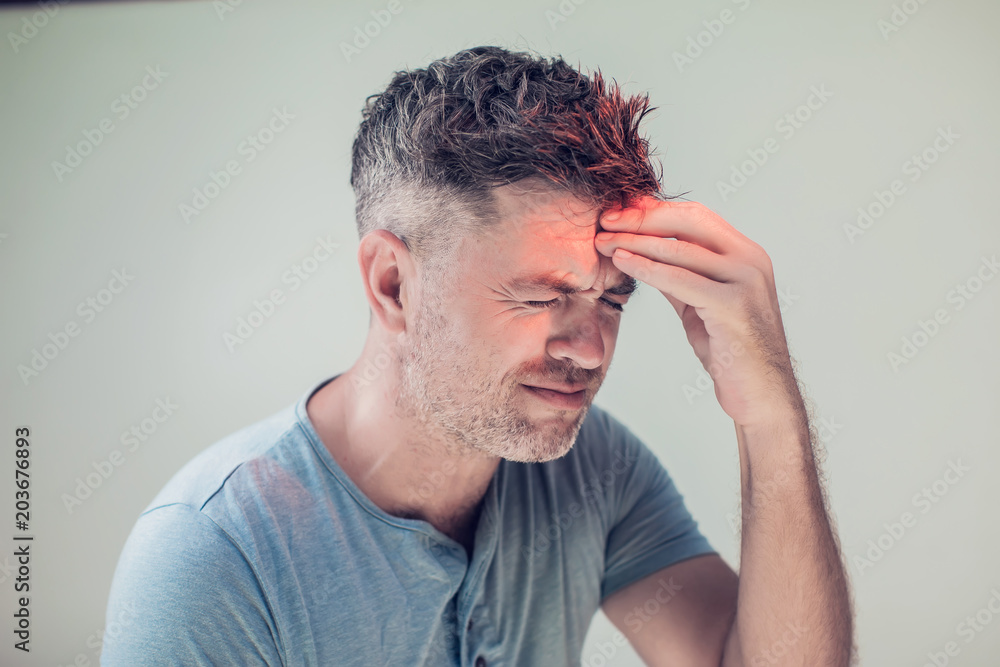 Fototapeta premium Handsome young man suffering from headache