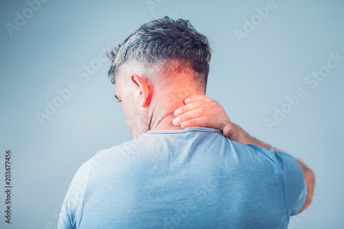 Young man suffering from neck pain. Headache pain.