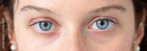 Blue eye of young caucasian woman photo