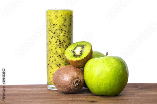 kiwi smoothie and apple on wooden table