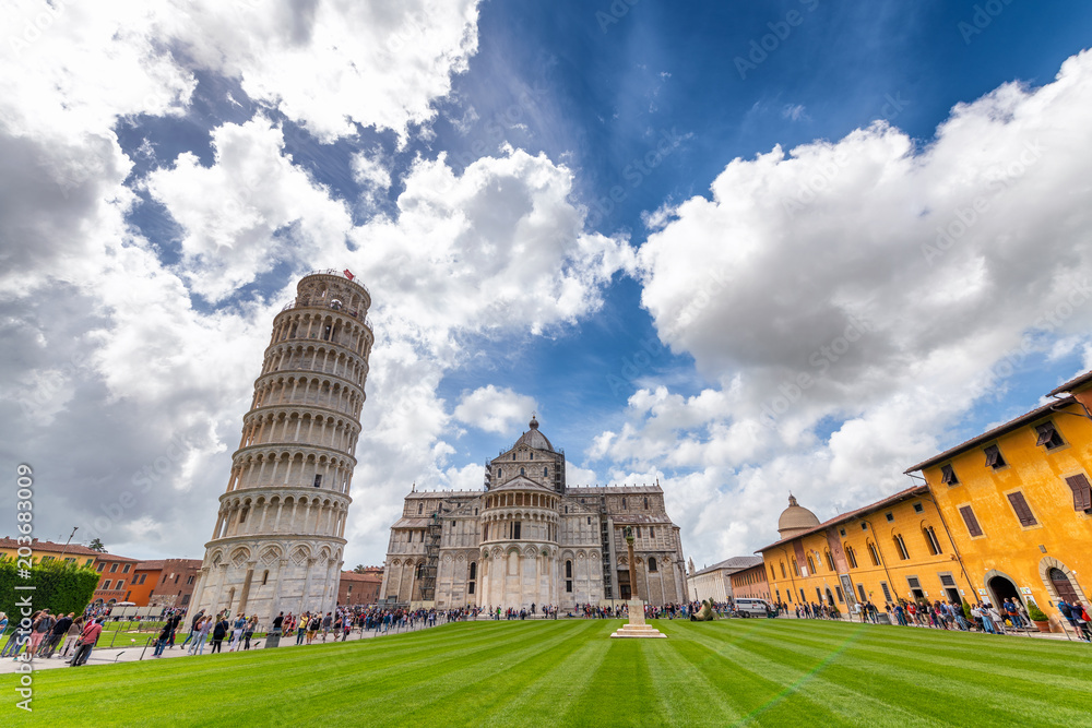 PISA, ITALY - APRIL 30, 2018: Tourists enjoy Square of Miracles. Pisa attracts 5 million tourists annually