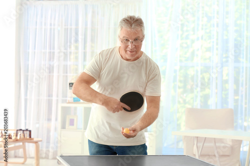 Senior man playing table te...