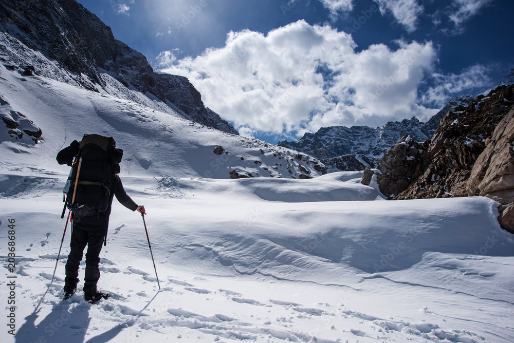 Men with backpack goes to the top of mountain in sun day Men with backpack goes to the top of mountain in sun day