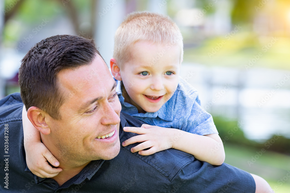 Fototapeta premium Young Caucasian Father and Son Having Fun At The Park