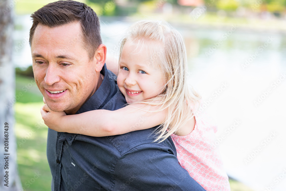 Fototapeta premium Young Caucasian Father and Daughter Having Fun At The Park
