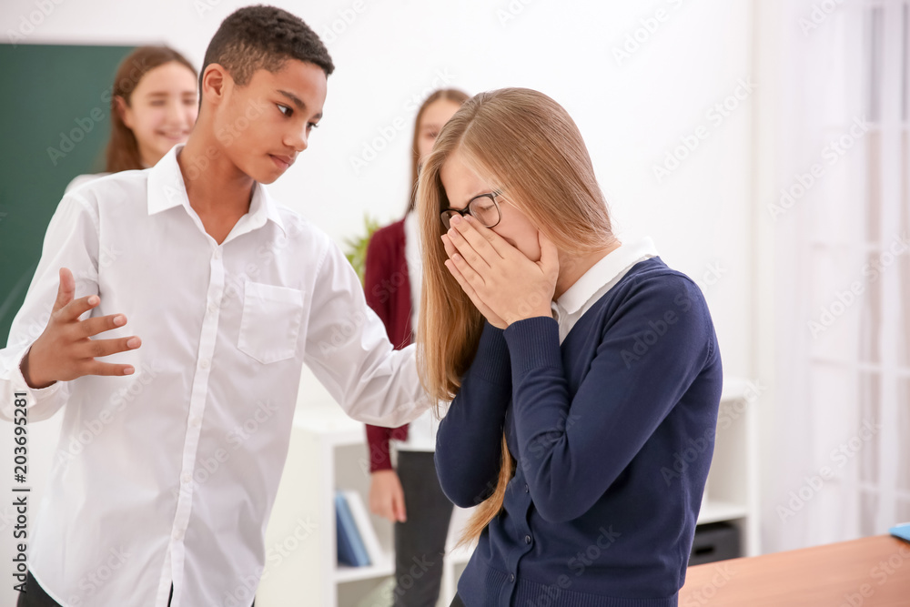 African American teen bullying his classmate in school African American teen bullying his classmate in school