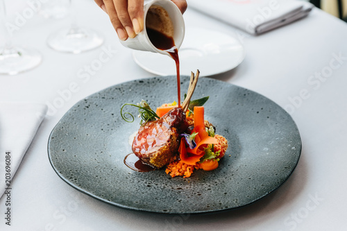 Modern French cuisine: Roasted Lamb neck & rack served with carrot, yellow curry pouring lamb sauce Fototapet