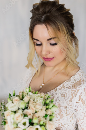 Beautiful woman in wedding dress in photo studio.