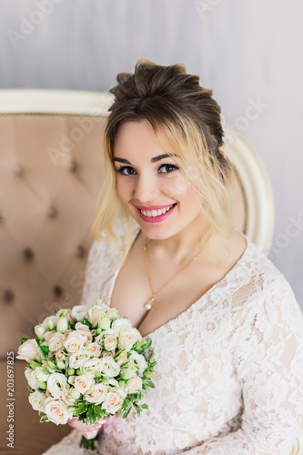 Beautiful woman in wedding dress in photo studio.
