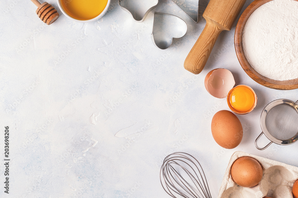 Ingredients for baking - flour, wooden spoon, eggs. Ingredients for baking - flour, wooden spoon, eggs.