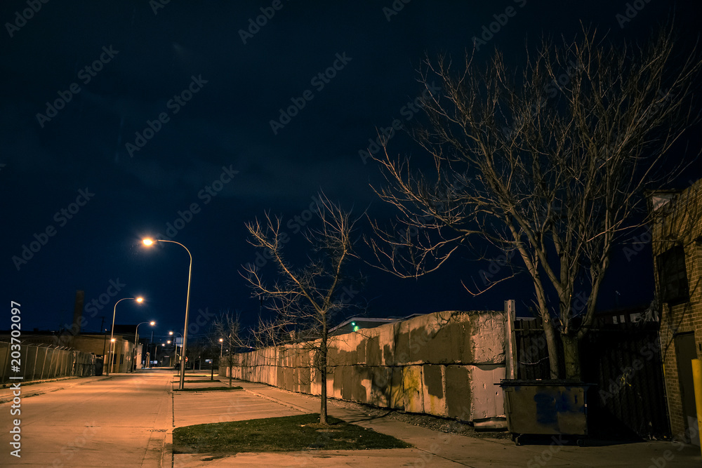 Dark and gritty industrial street scenery at night