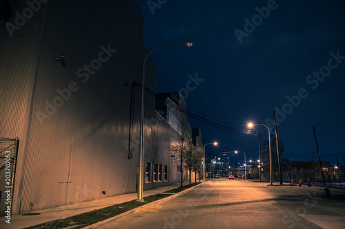 Industrial urban street city night scenery in Chicago with vintage warehouses and the skyline in the background
