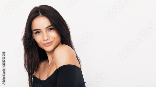 Close up portrait of an attractive woman in black dress with open shoulders © Artem Varnitsin