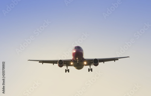 big commercial airplane at landing with clear blue sky background