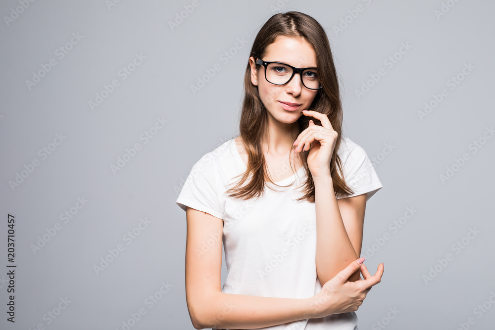thinking woman looking up with hand on chin and copyspace isolated on grey background thinking woman looking up with hand on chin and copyspace isolated on grey background