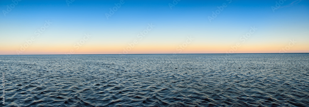 Fototapeta premium Panorama of sea waves on the background of dawn
