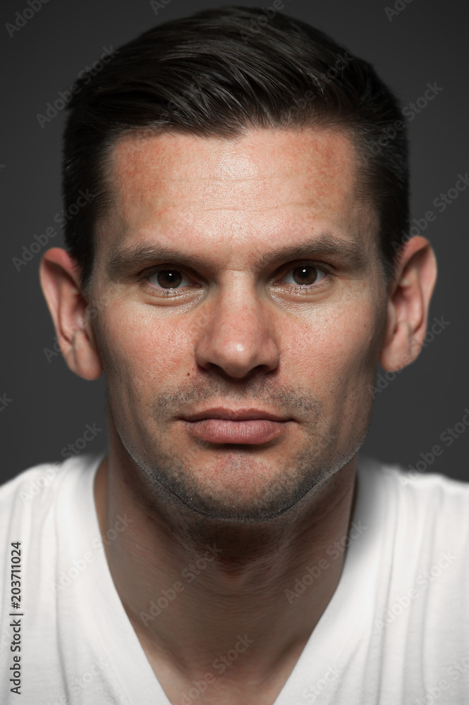 Close-up portrait of positive caucasian man on gray background Close-up portrait of positive caucasian man on gray background