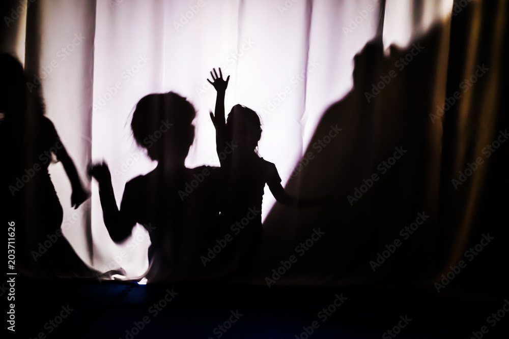 Children's silhouette. The concept of child protection. Children's performance in the theater.
