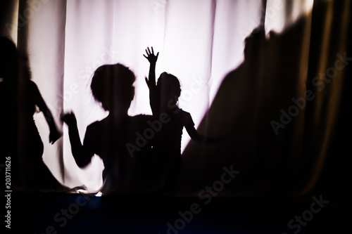 Children's silhouette. The concept of child protection. Children's performance in the theater.