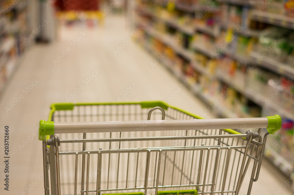 Shopping cart in supermarket,blur focus.