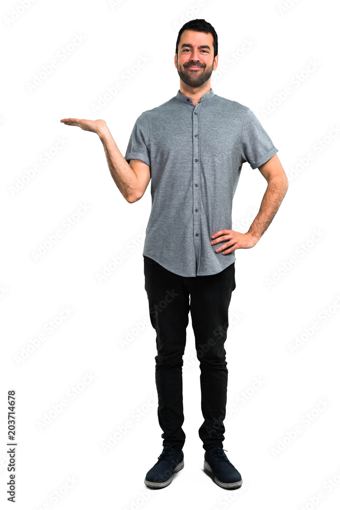 Handsome man holding copyspace imaginary on the palm Handsome man holding copyspace imaginary on the palm
