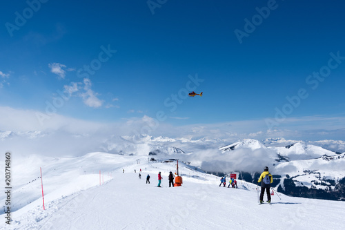 Mountain rescue helicopter above Alps, Kitzbuhel, Austria