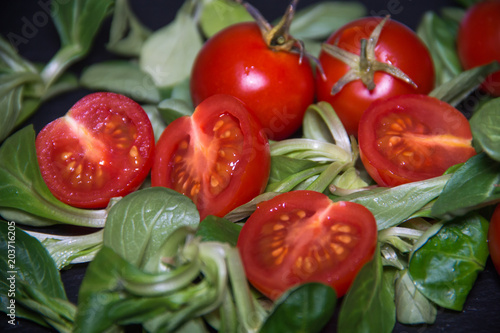 Close up view of tomato and songino salad on a slate plate photo