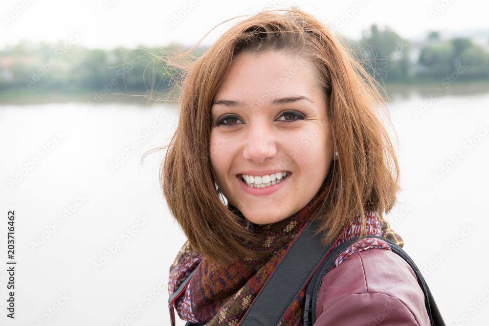 pretty young woman in winter smile and happy in city river