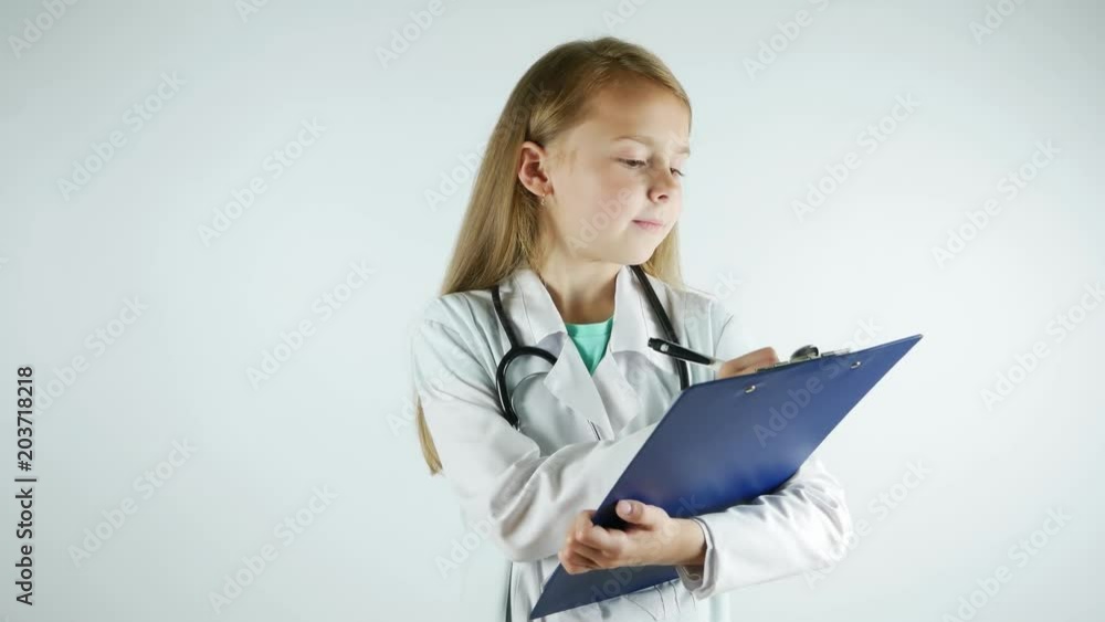 Lovely little girl shows serious doctor, writes medical prescription. Lovely little girl shows serious doctor, writes medical prescription.