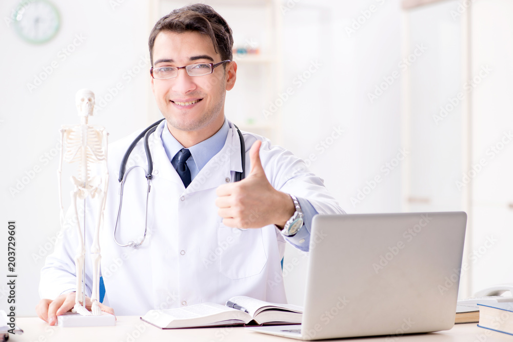 Doctor explaining human body on skeleton