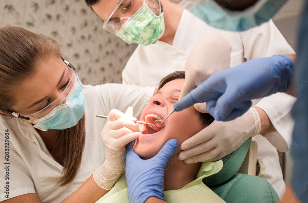 Boy with perfect teeth at the dentist doing check up with the clinic at the background - oral hygiene health care concept Boy with perfect teeth at the dentist doing check up with the clinic at the background - oral hygiene health care concept