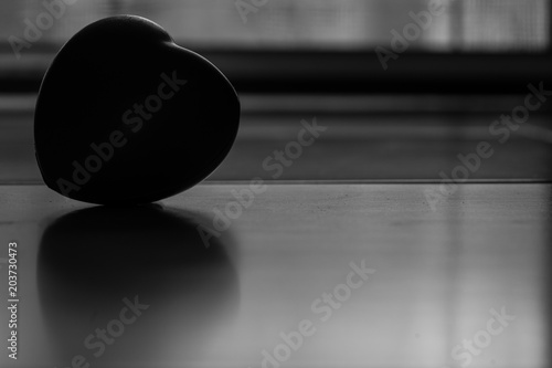 silhouette heart rubber on floor and back light background photo