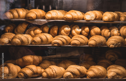 A lot of fresh homemade croissants Sold in a small bakery.