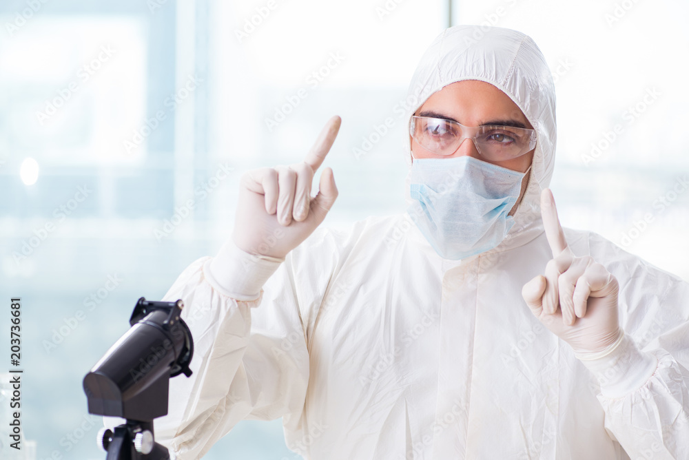 Young chemist pressing virtual buttons in lab Young chemist pressing virtual buttons in lab