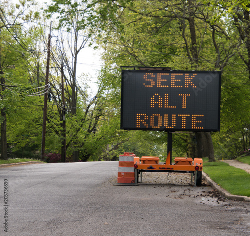 Canvas Print Seek alternate route LED sign on tree lined road