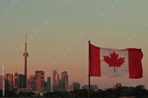 Photography Canada Flag and Toronto CN Tower at the sunset in summer