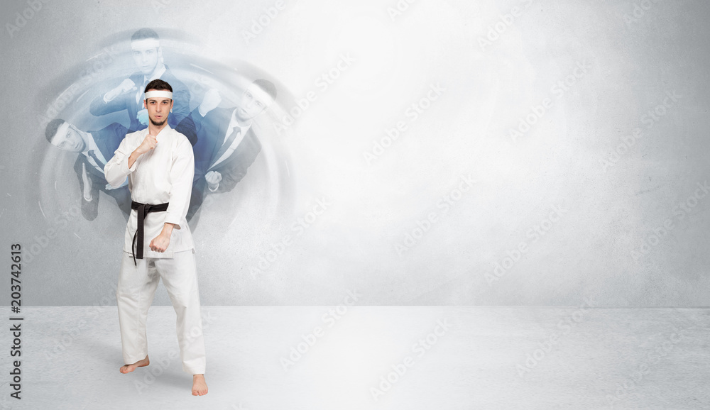 Young businessman in suit fighting with empty wall background
Young businessman in suit fighting with empty wall background