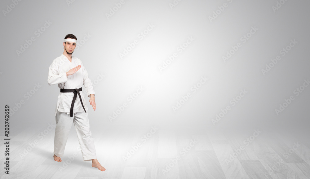 Young kung-fu trainer fighting in an empty space
Young kung-fu trainer fighting in an empty space