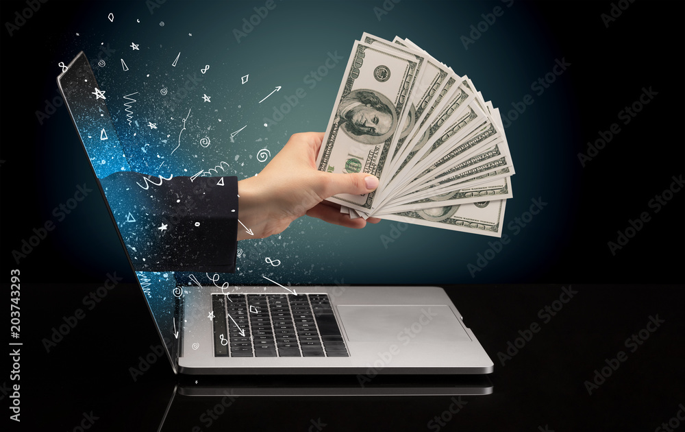 Hand with money coming out of a laptop with sparkling effects