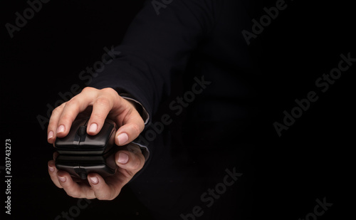 Hand using wireless mouse in a dark environment 