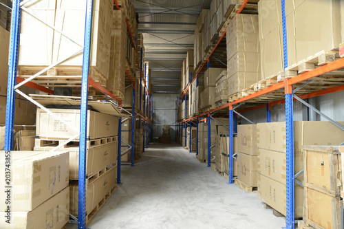 warehouse of industrial goods in boxes on iron shelves for transportation to customers