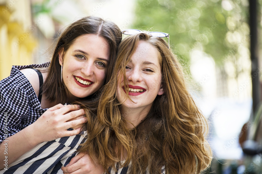 Obraz premium Two lovely girls having fun on the street. Bff conception. 
