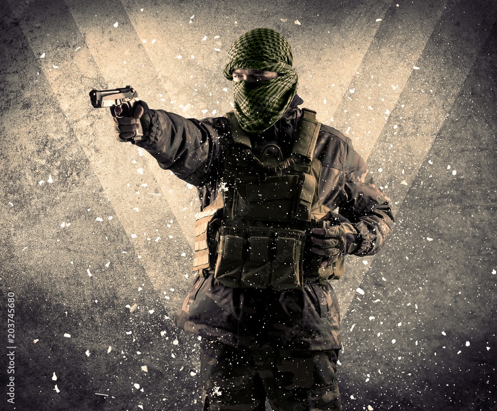 Portrait of a dangerous masked armed soldier with grungy light background Portrait of a dangerous masked armed soldier with grungy light background