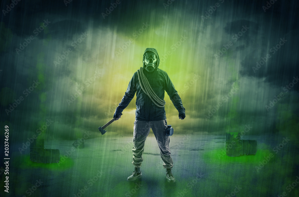 Fototapeta premium Masked unrecognizable guard in an abandoned space after explosion