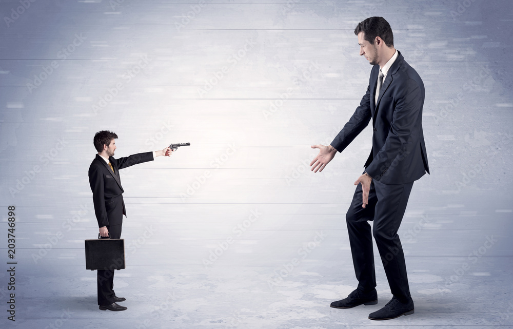 Tiny businessman with gun shooting giant fearful businessman
Tiny businessman with gun shooting giant fearful businessman