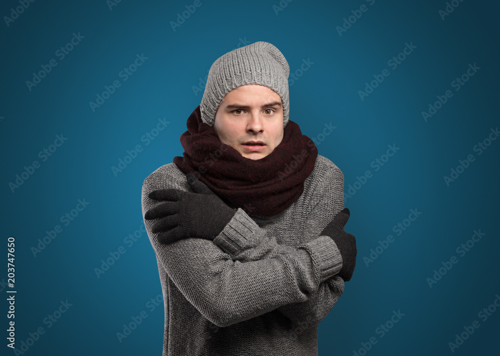 Handsome young boy freezing in warm clothing with copy space Handsome young boy freezing in warm clothing with copy space