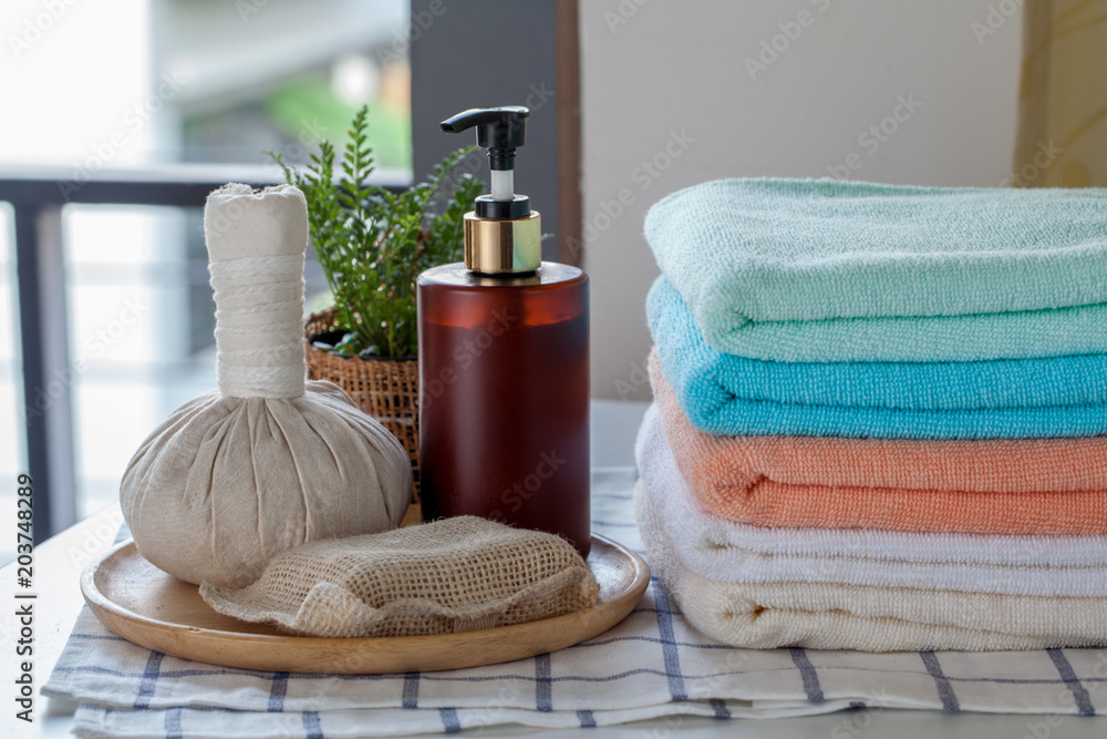 Stack of bath towels with toothbrushes on table Stack of bath towels with toothbrushes on table